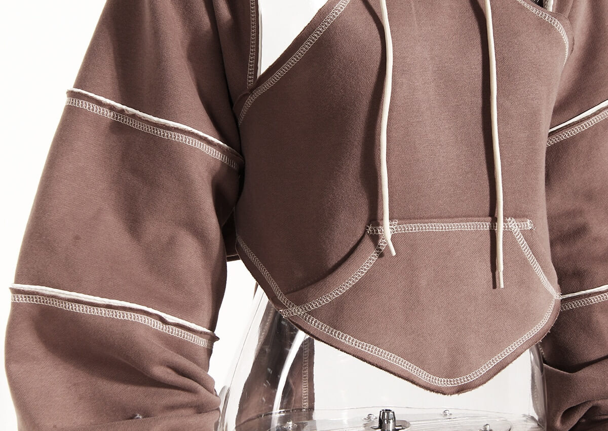 Hollow out long sleeves hooded sweatshirt in brown, showcasing trendy crop design for modern women.