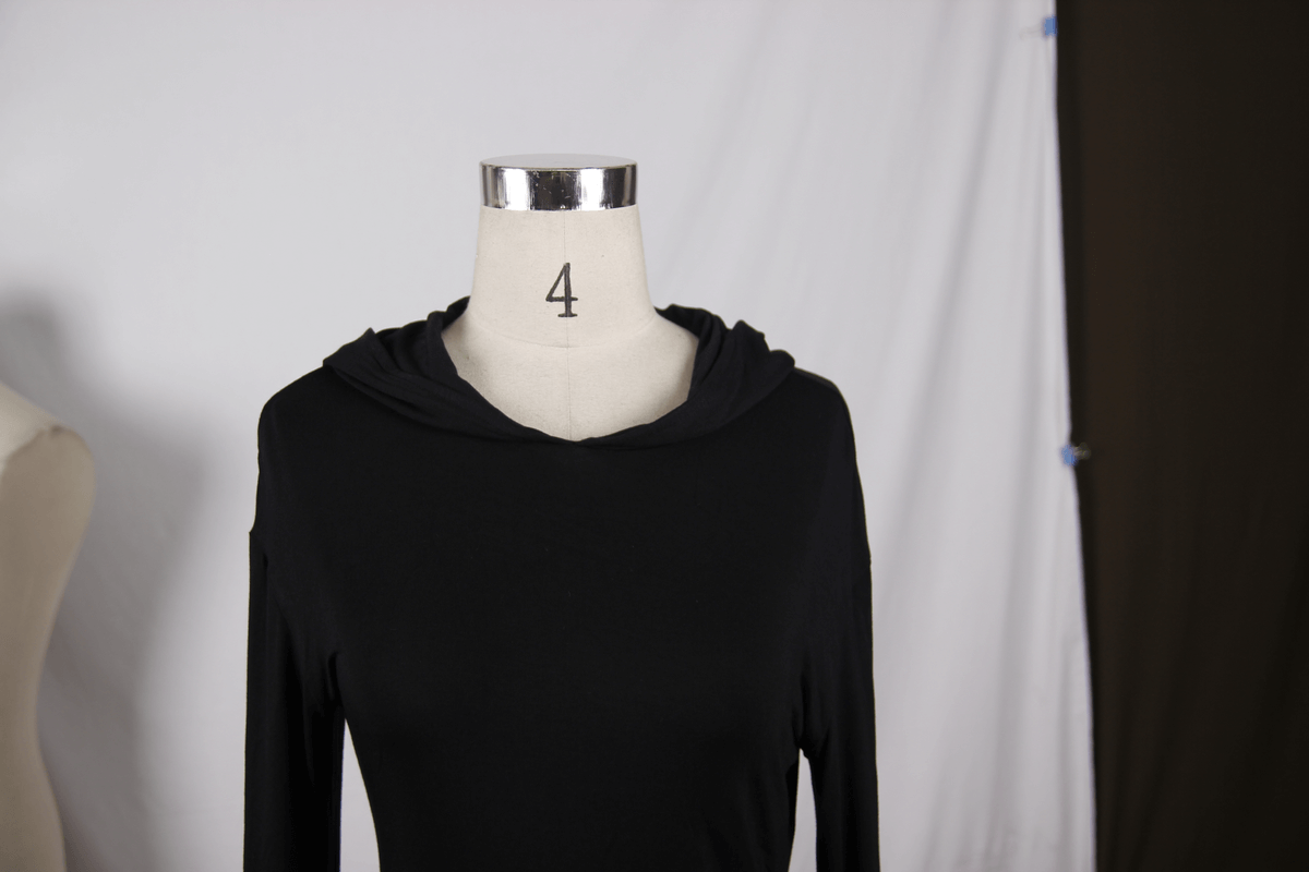 Hooded black mini dress with long sleeves, showcasing gothic style and modern cut, perfect for alternative fashion enthusiasts.