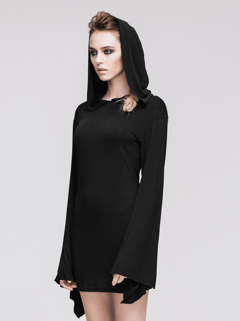 Model in a black hooded mini dress with flared sleeves, showcasing gothic alternative fashion style.