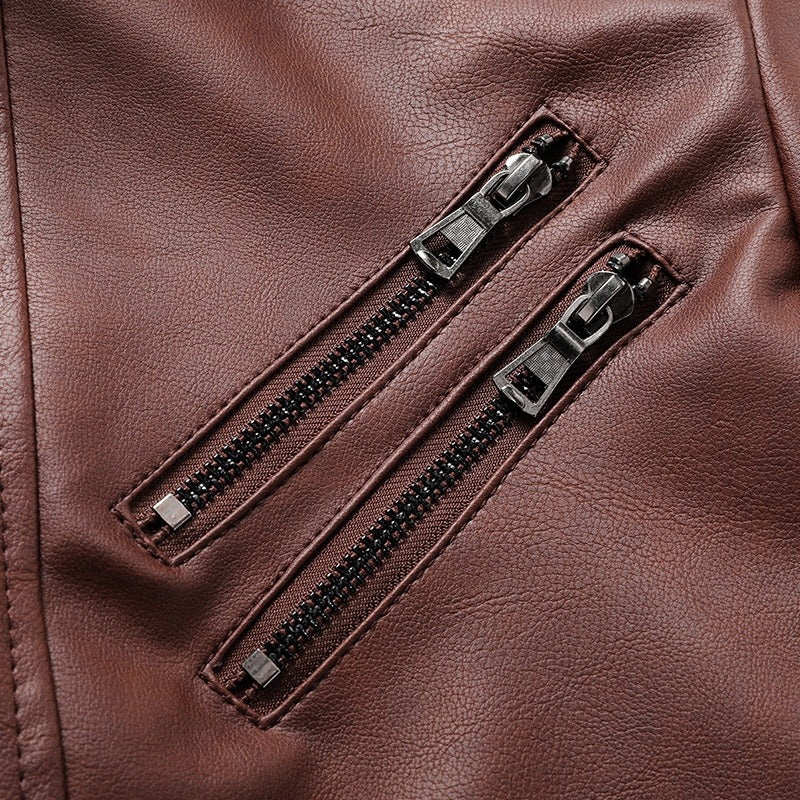 Close-up of brown faux leather zippers on a stylish men's motorcycle jacket, showcasing its rock-inspired design.