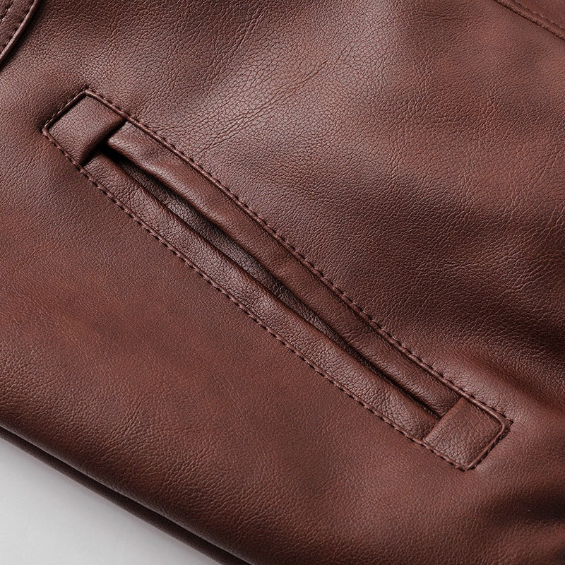 Close-up of the sleek brown leather pocket on a men's hooded jacket, showcasing quality craftsmanship and style.