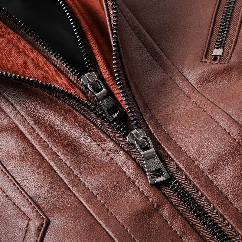 Close-up of zippers on a stylish brown men's leather motorcycle jacket showcasing quality and design.