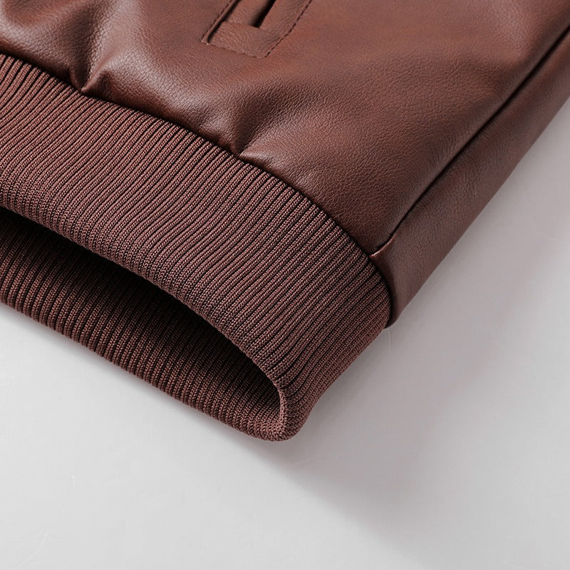 Close-up of brown leather jacket sleeve with ribbed cuff, showcasing stylish casual design and high-quality material.