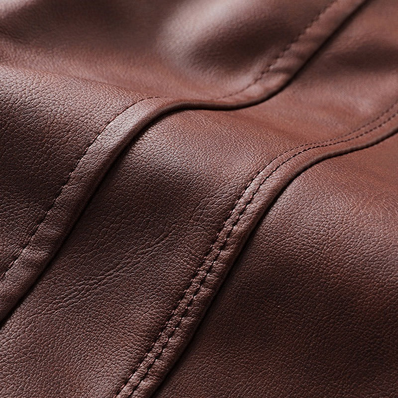 Close-up of rich brown faux leather texture with detailed stitching, perfect for men's motorcycle jackets.