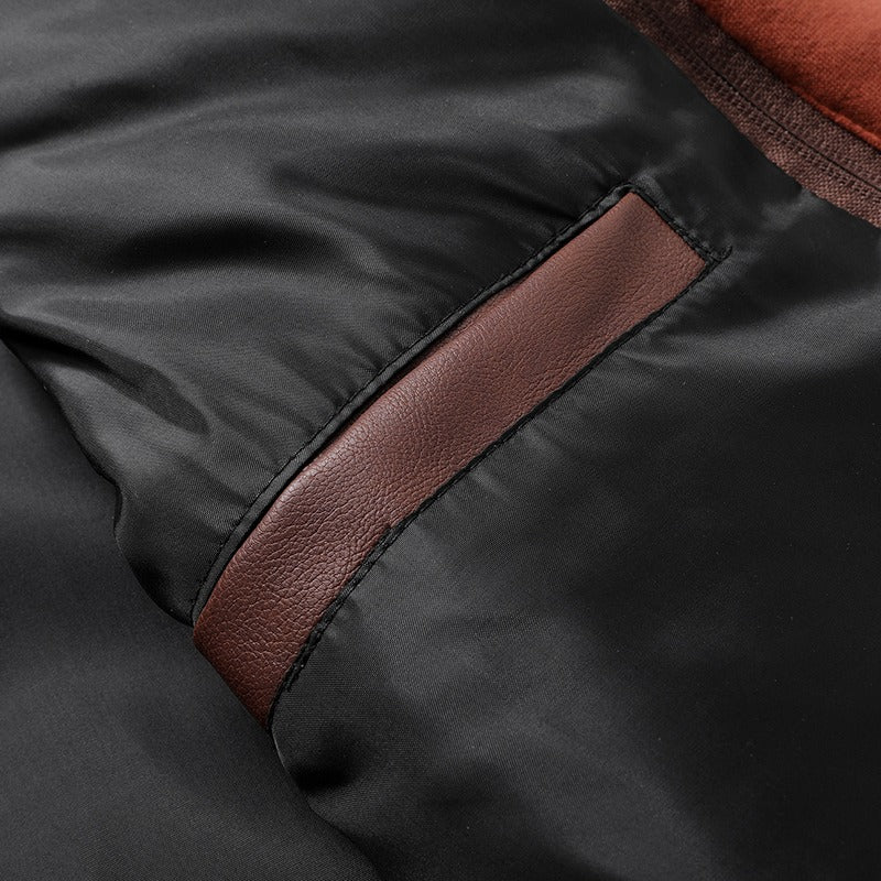 Close-up of the interior detail of a hooded leather jacket with a stylish brown accent pocket.
