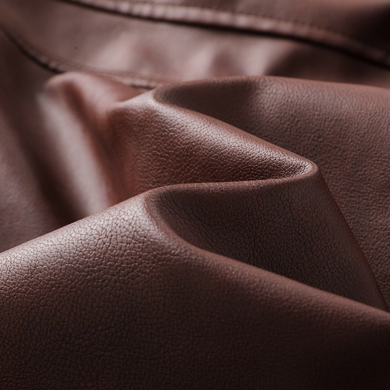 Close-up of soft brown faux leather fabric, perfect for stylish hooded leather jackets and motorcycle wear.