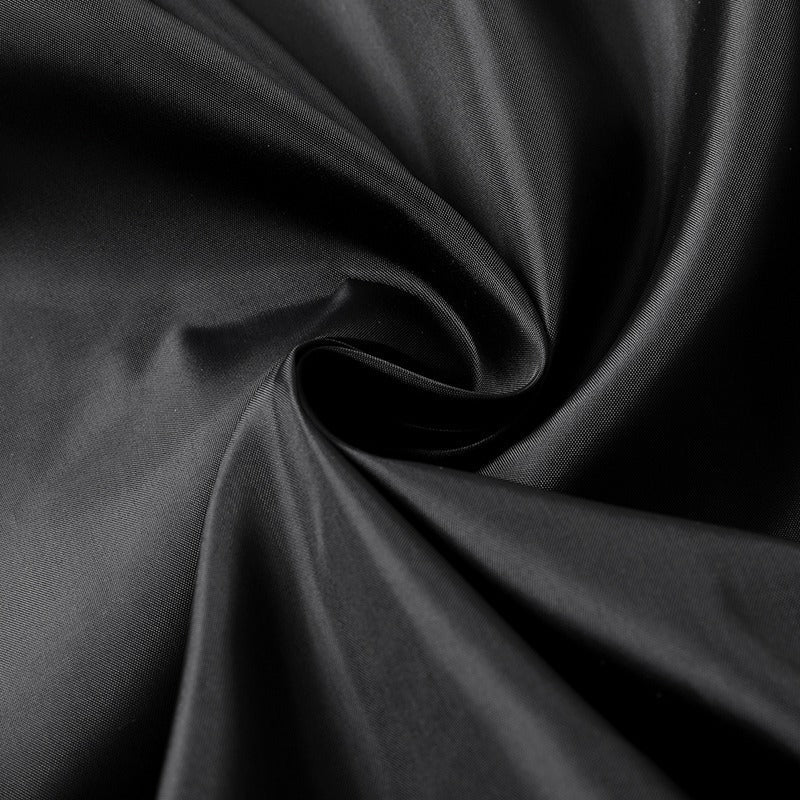 Close-up of smooth black fabric, showcasing the texture of polyester and imitation leather for jackets.
