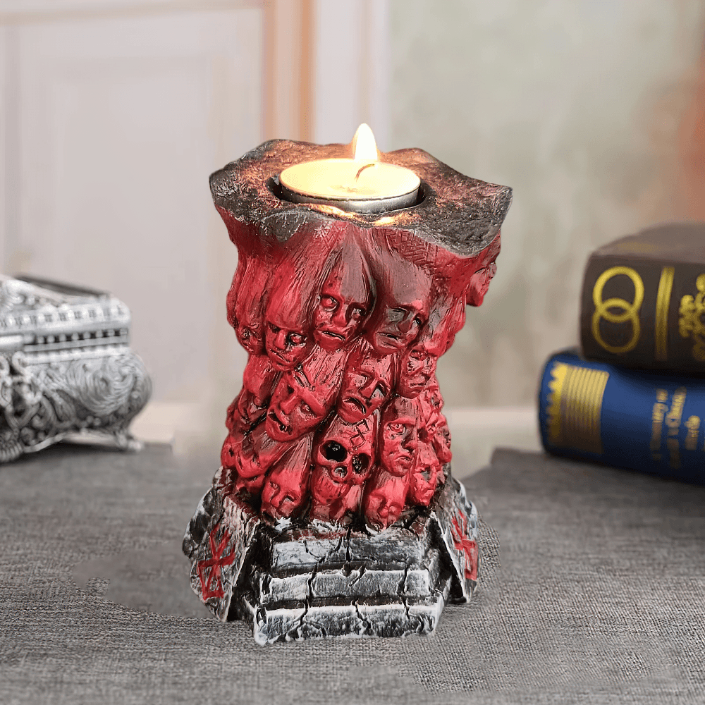 Horror Skull Tealight Holder for Gothic Decor featuring eerie red resin with carved faces and tealight candle.