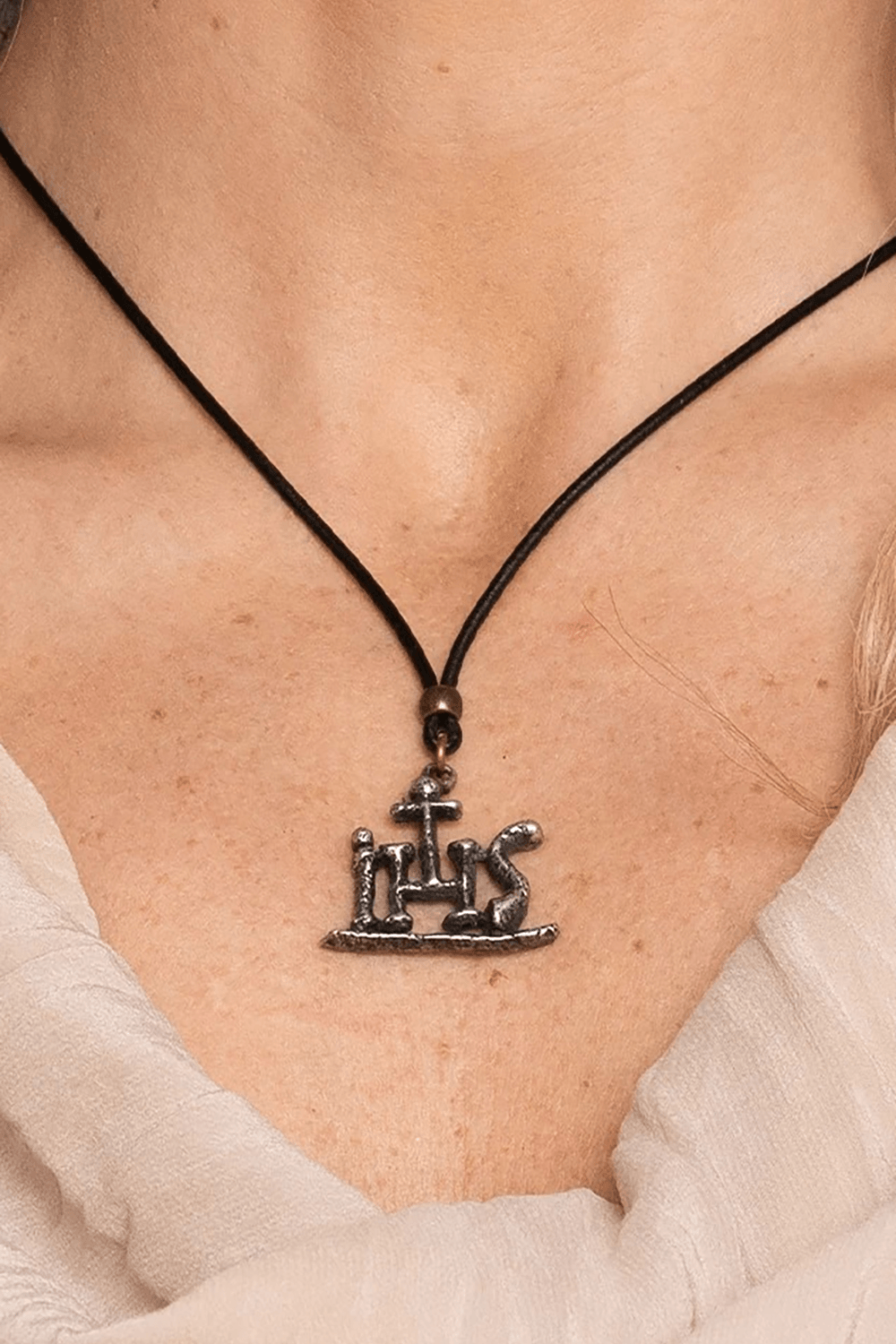 IHS Christogram Pewter Amulet Gothic Pendant Necklace displayed on a person's neck, showcasing its ancient symbolism.