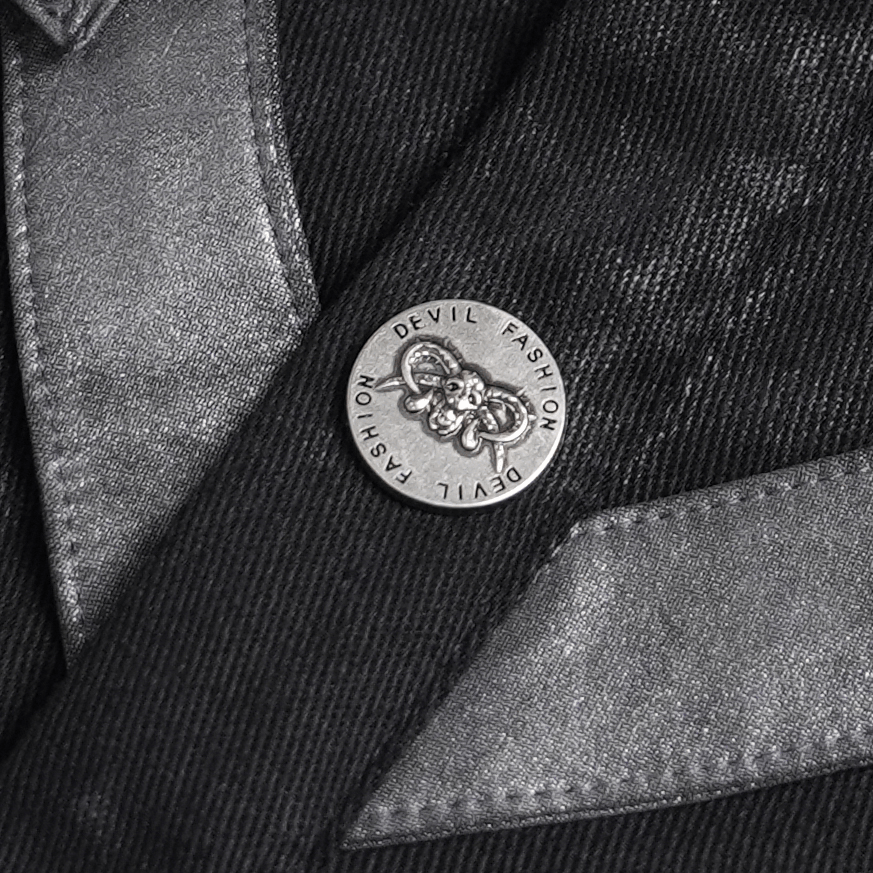 Close-up of the button on the Industrial Gothic Buckle Strap Sleeveless Shirt featuring Devil Fashion branding.
