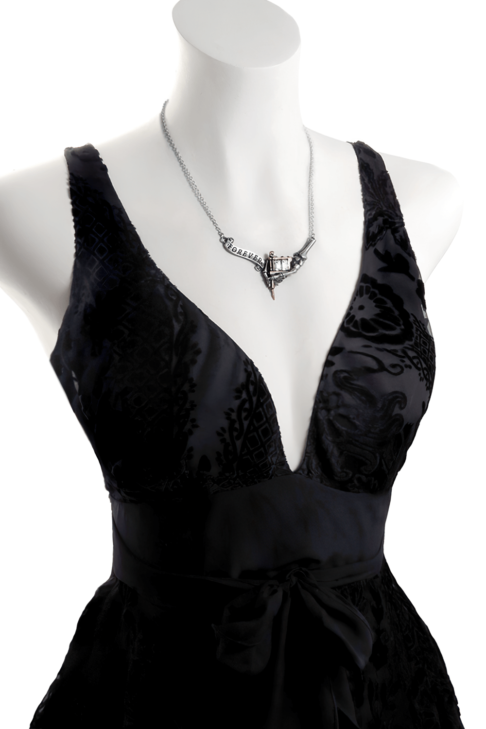 Inked Skull Necklace with Ribbon Forever and Crystals displayed on a stylish black dress, highlighting its unique design.