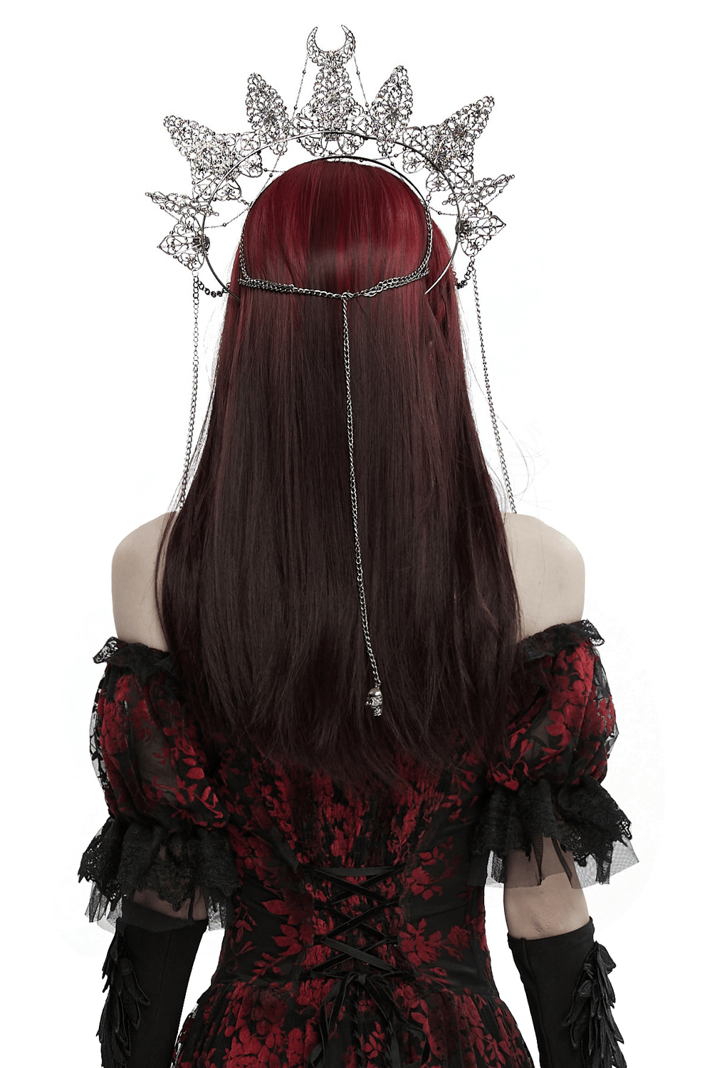 Back view of a model wearing an intricate metal crown with skull pendants and chains, showcasing gothic elegance.