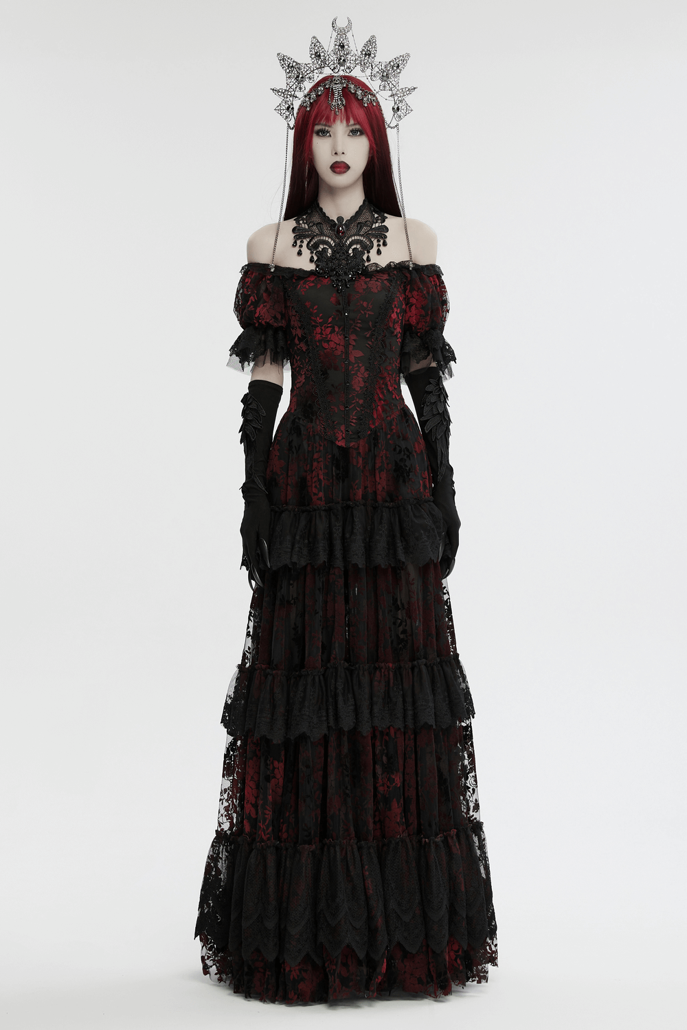 Gothic queen wearing a stunning black and red dress with an intricate metal crown and elegant lace details.