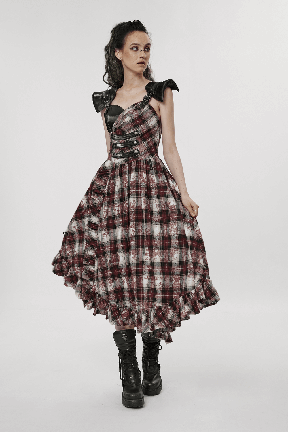 Punk chic plaid dress with adjustable leather straps and ruffle hem, perfect for a rebellious style.