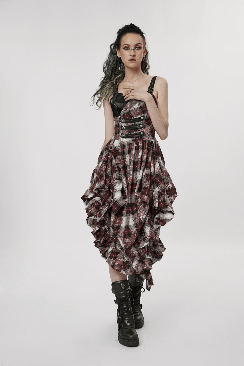 Punk plaid dress with adjustable leather straps and irregular hem, embodying edgy fashion and rebel style.