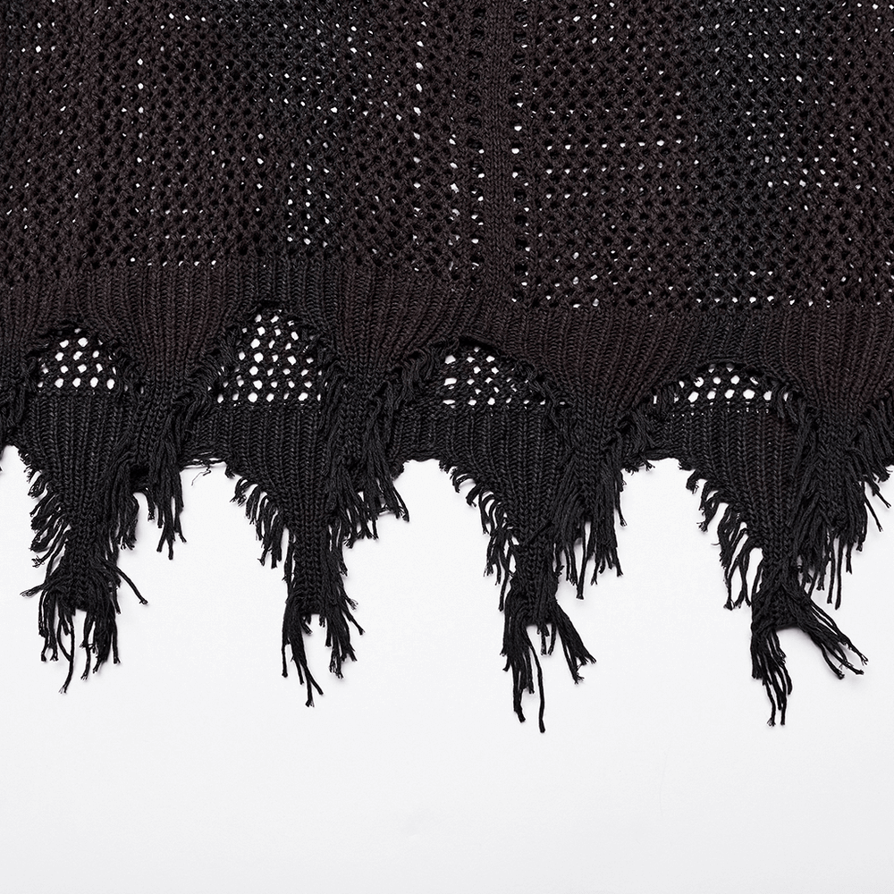 Close-up of textured black knitted fabric with fringe hem, showcasing unique post-apocalyptic techwear style.