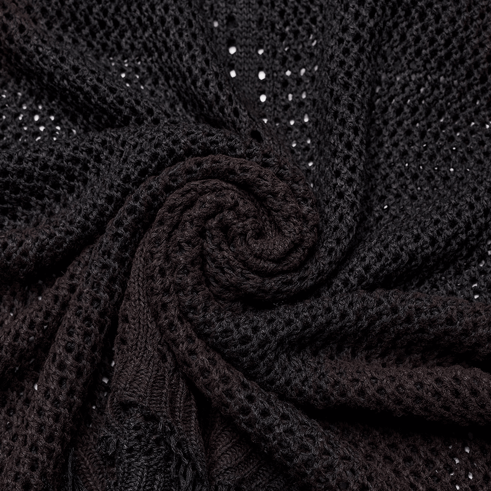 Close-up of black knitted fabric showcasing textured, hollow design for post-apocalyptic techwear style.