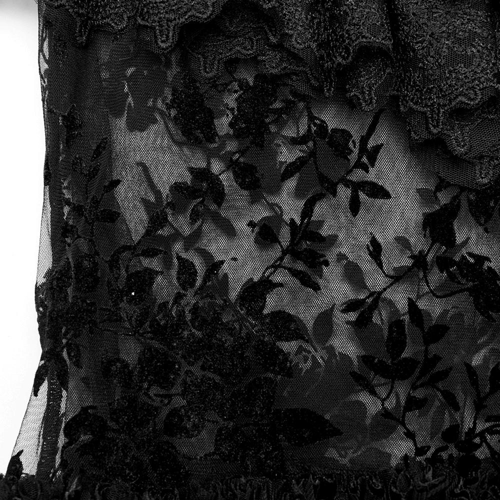 Close-up of a black lace-adorned mesh with intricate floral flocking details, showcasing gothic elegance.