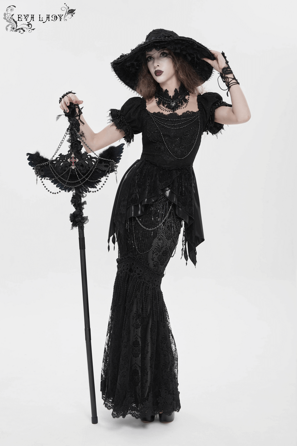 Lace and Fringe Black Skirt with Chains for Elegance Style worn by a model with a dramatic hat and parasol.