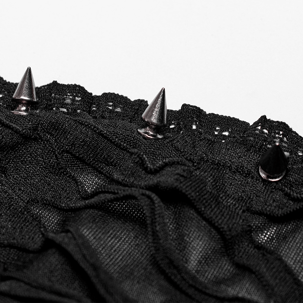 Close-up of lace and metal rivets on a gothic bustier, showcasing punk-inspired details and elegant texture.
