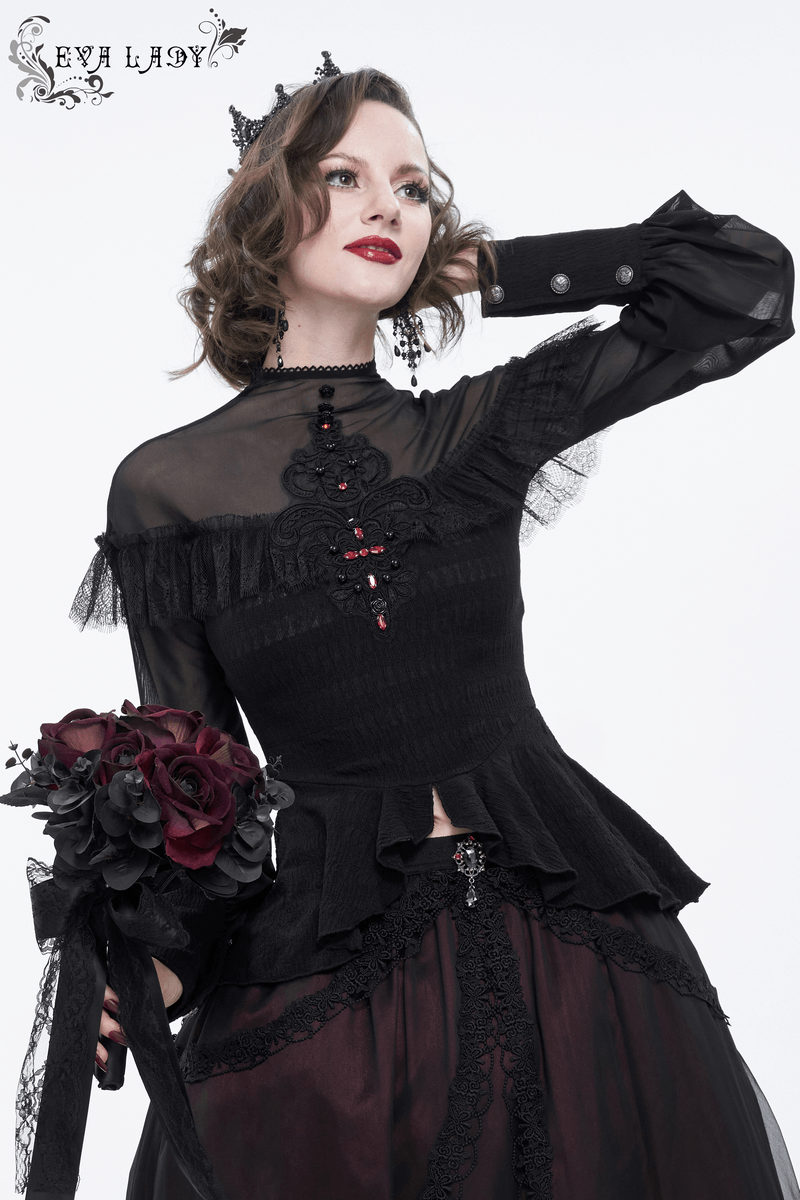 Elegant woman in a black lace applique beading blouse with long sheer sleeves, holding a bouquet of dark roses.