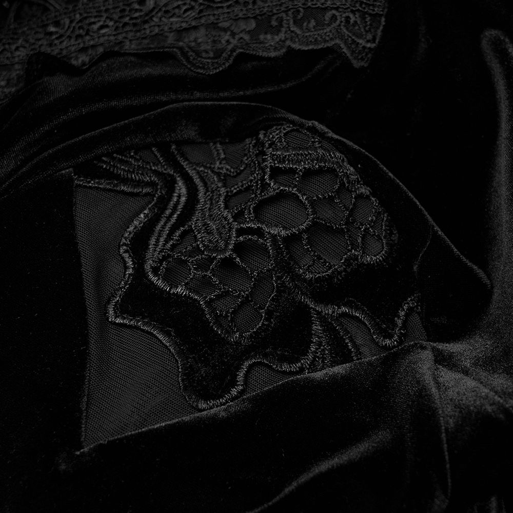 Close-up of elegant black velvet fabric with intricate lace detailing, perfect for a gothic dress.