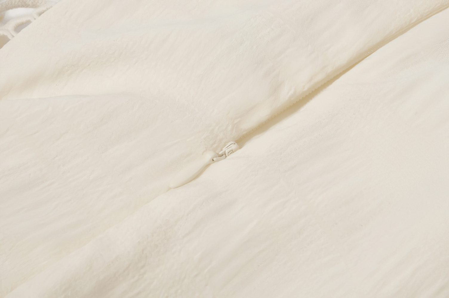 Close-up of the delicate ivory fabric of the Lace Corset Dress with Puff Sleeves and Tiered Skirt.