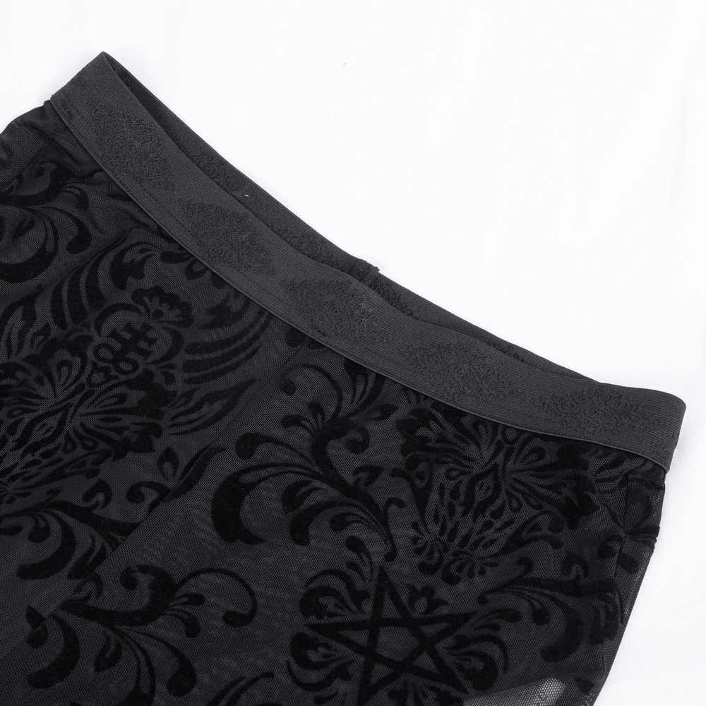 Close-up of gothic lace flare pants featuring intricate velvet patterns and lace details on the waistband.