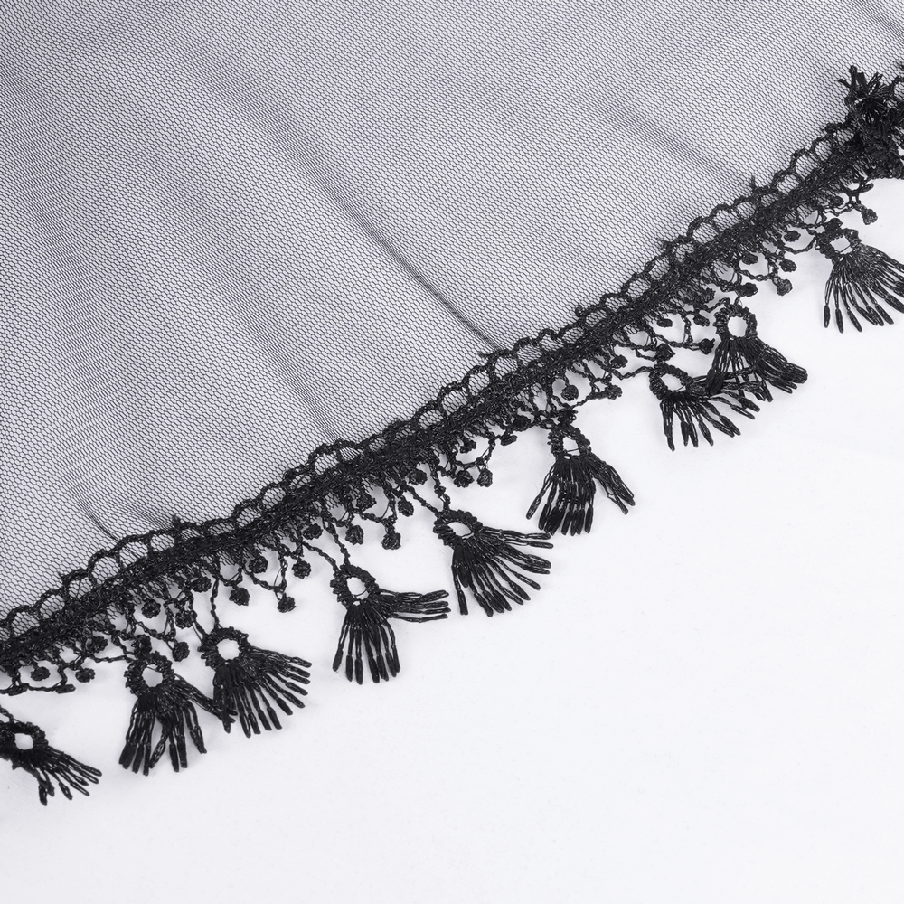 Close-up of black lace fabric with intricate fringe detailing, perfect for gothic-inspired fashion.