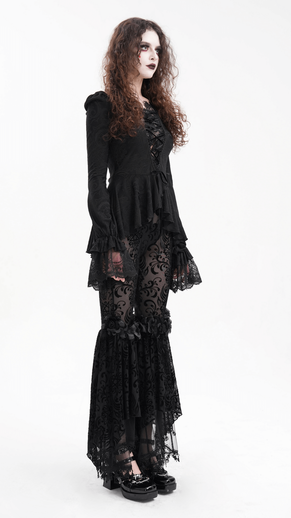 Gothic lace flare pants with velvet patterns, styled with a dramatic black top and lace ruffles, exuding dark elegance.