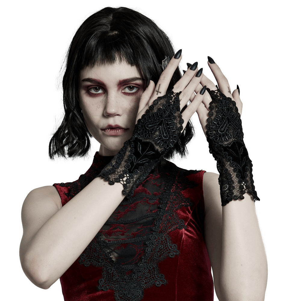 Elegant gothic gloves with lace floral pattern and heart decal, showcased by a model in a dark romantic outfit.