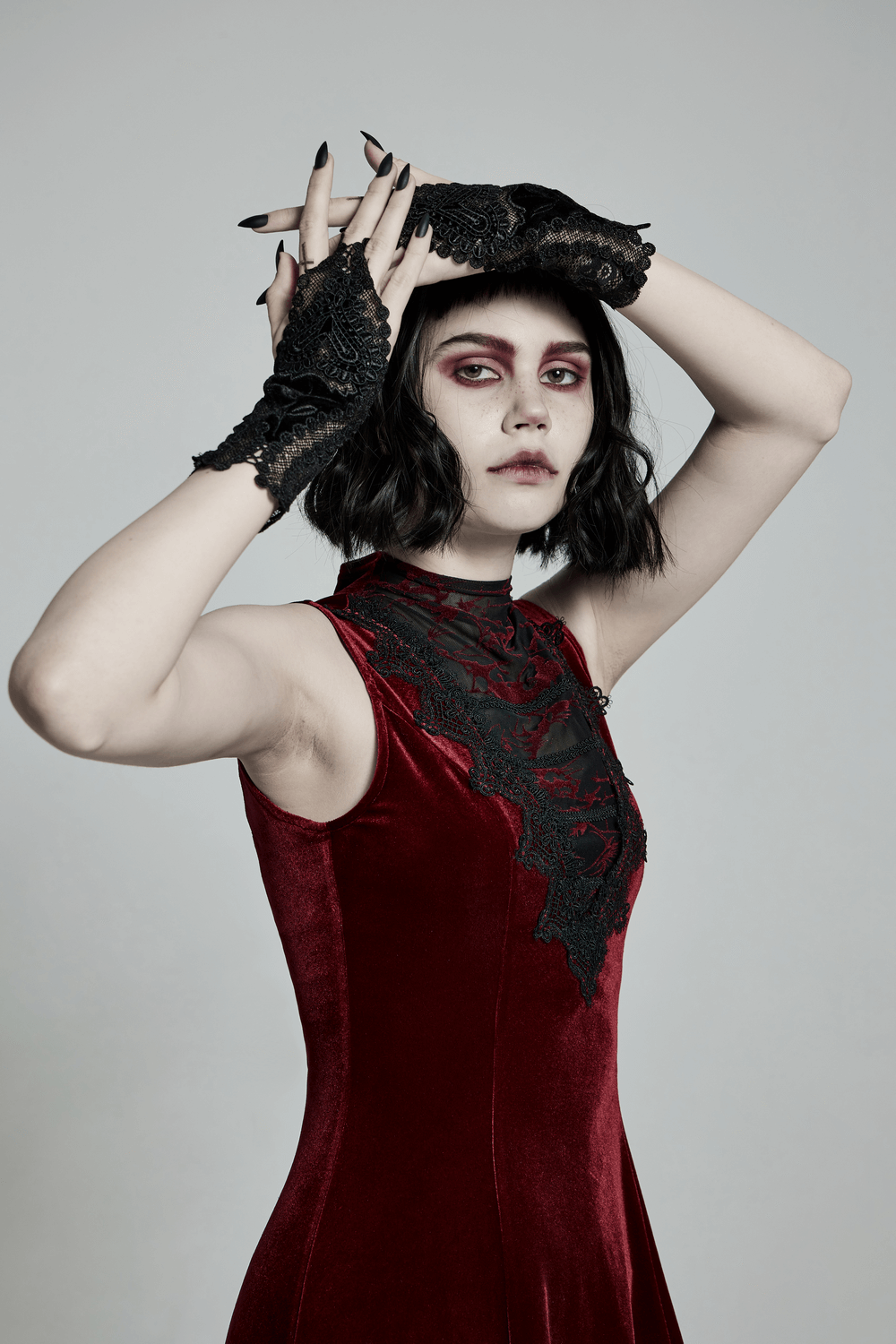 Elegant model wearing Lace Floral Gothic Gloves with dark romance style in a red velvet dress.