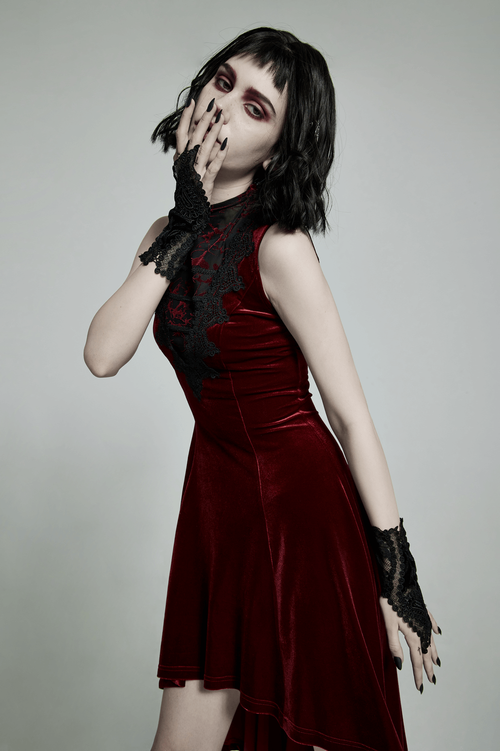 Model showcasing Lace Floral Gothic Gloves with heart decal detail, styled with a red velvet dress for a dark romantic look.