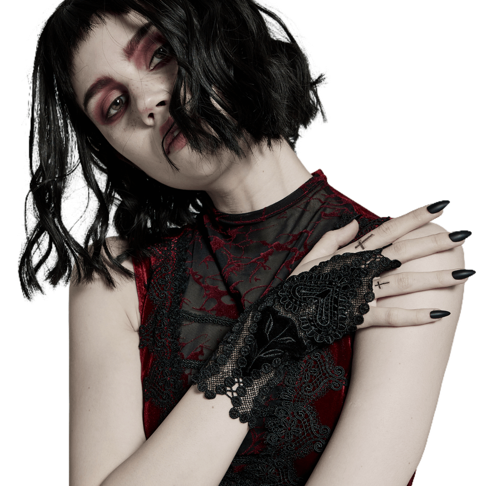 Gothic lace gloves with heart decal, worn by a model in a dark romantic setting.