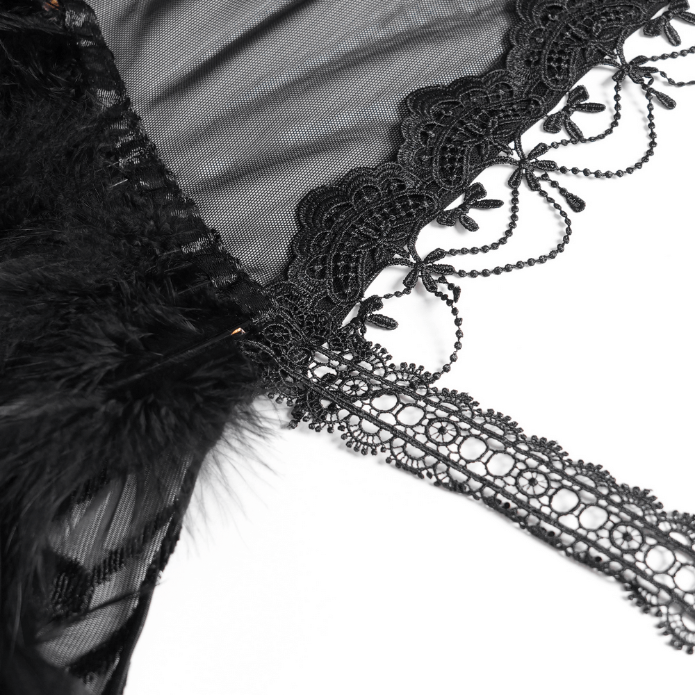 Close-up of black lace Gothic cape detailing with roses, feathers, and intricate lace trim.