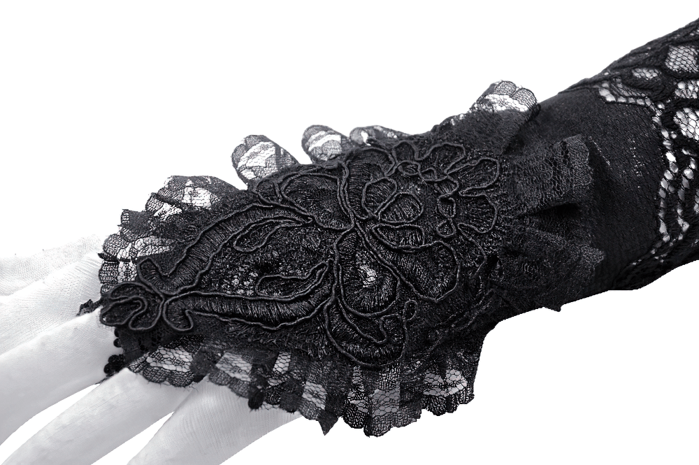 Elegant black lace long fingerless glove with frills and floral detailing on a mannequin hand.