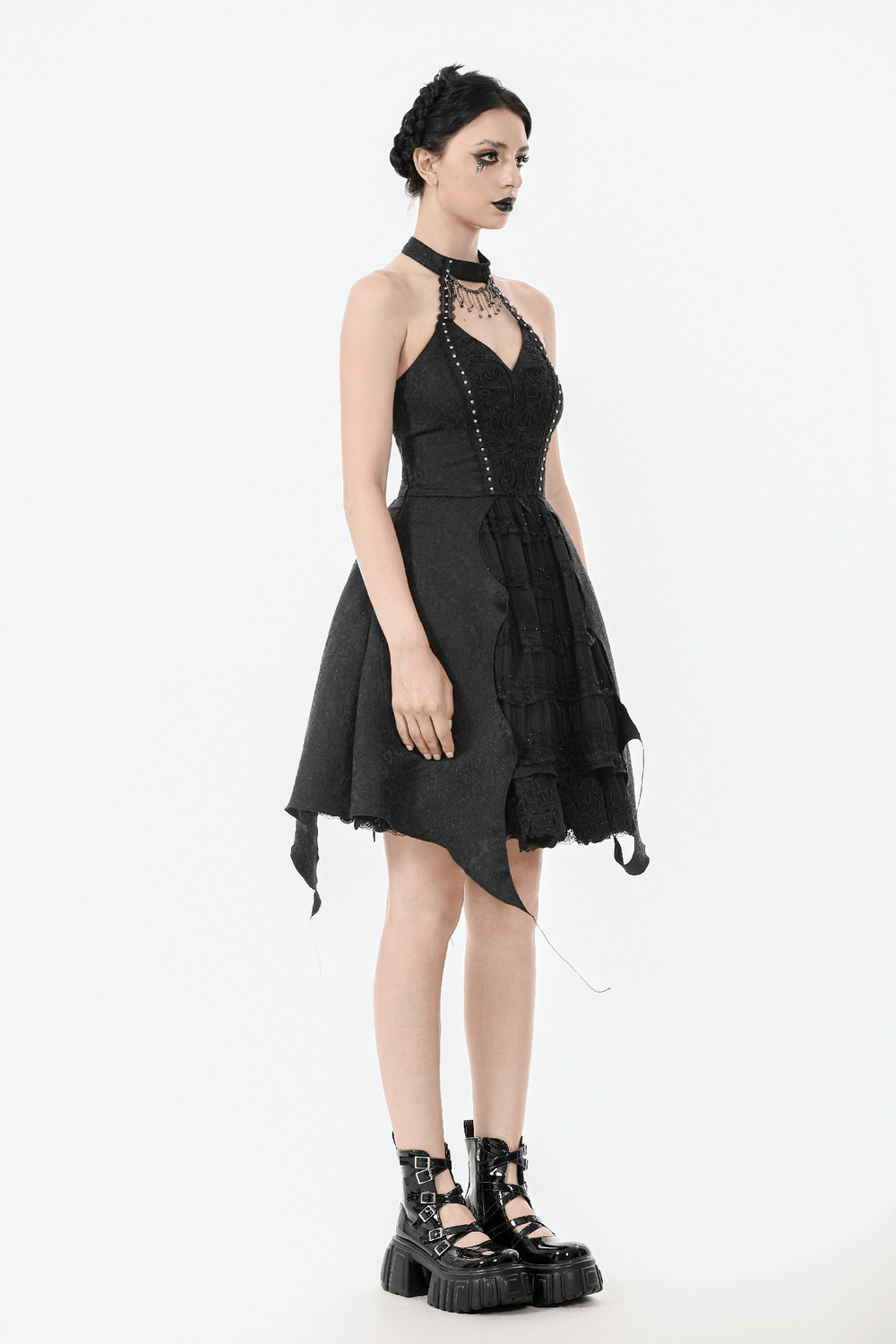 Lace halter corset dress with choker and asymmetrical hem, styled with edgy platform boots.