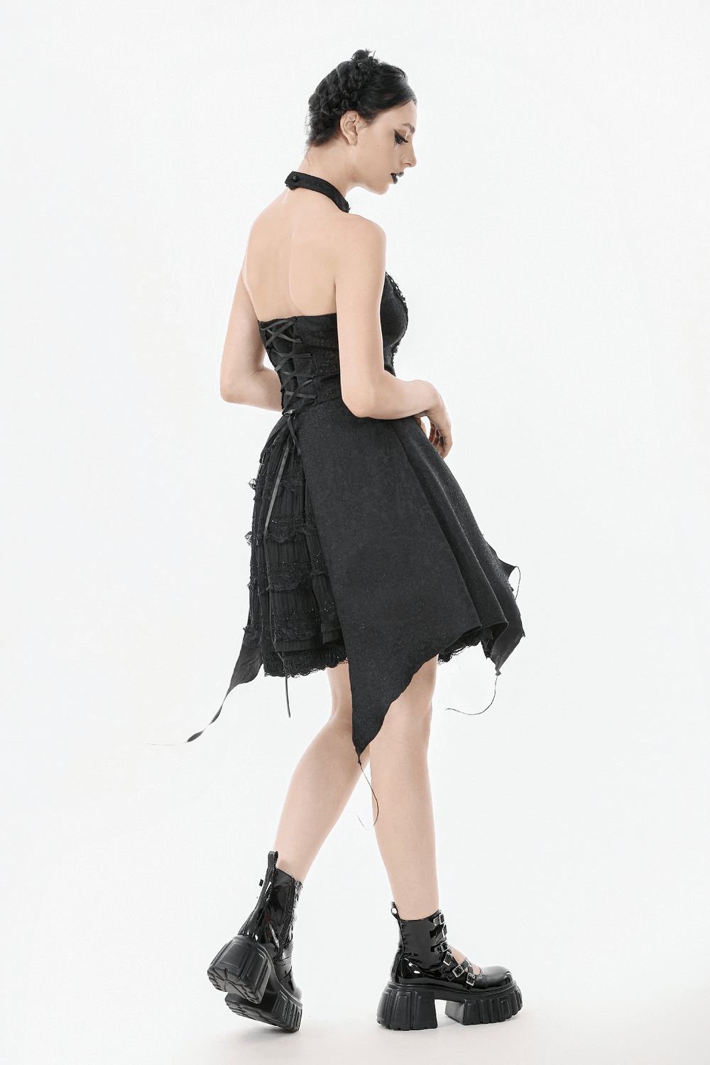 Lace halter corset dress with choker, asymmetrical hem, and trendy black platform boots for a stylish look.