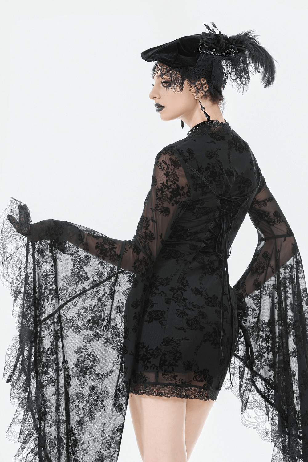 Lace Mini Dress with Bell Sleeves and Back Lace-up Design showcasing elegant floral patterns and dramatic flowing sleeves.