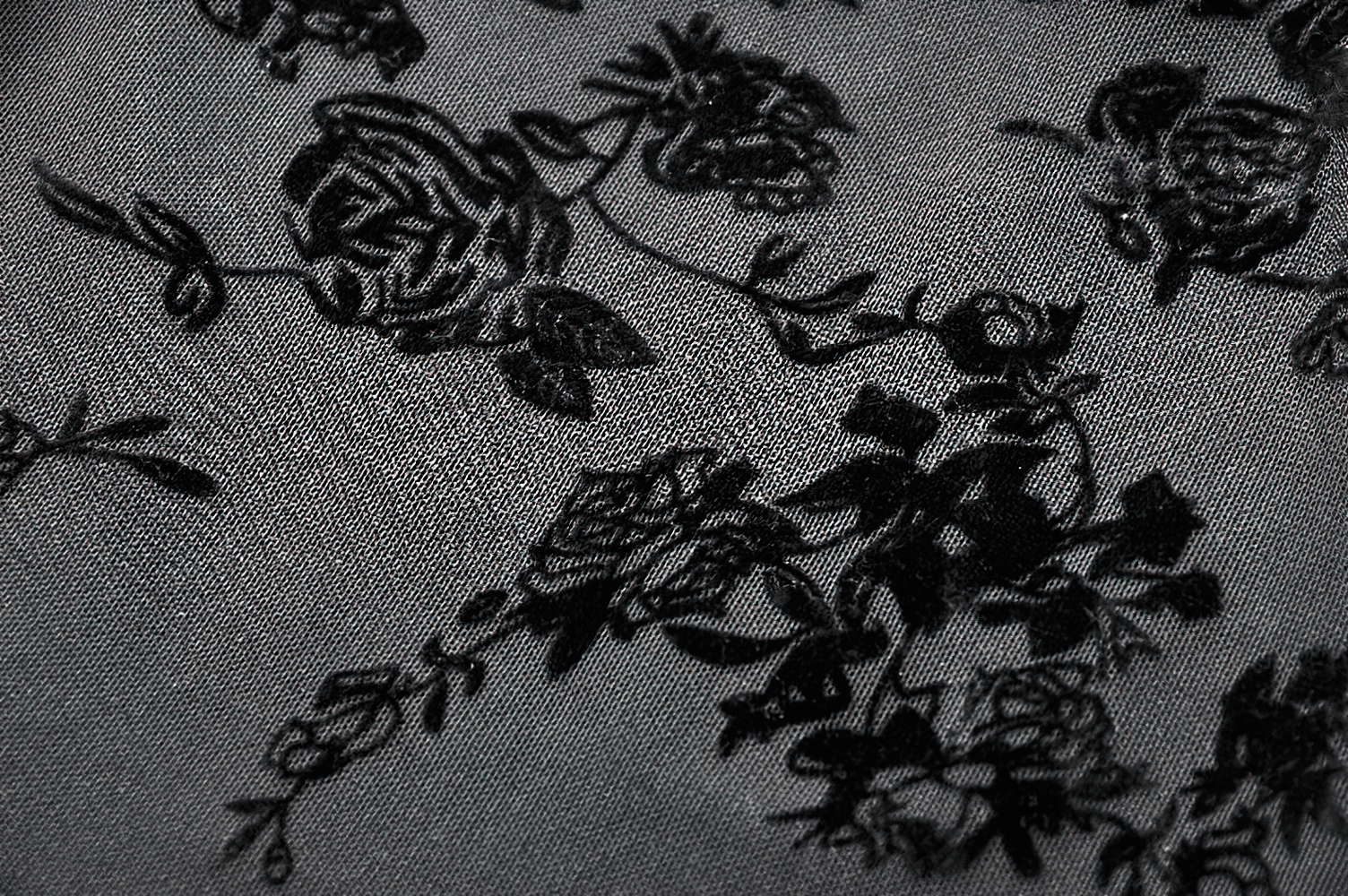 Dark floral lace fabric showcasing intricate black roses, perfect for a Lace Mini Dress with Bell Sleeves and Back Lace-up Design.