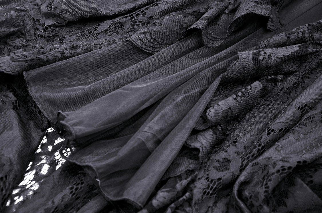 Close-up of dark lace fabric with intricate detailing, showcasing the elegant texture and gothic appeal.