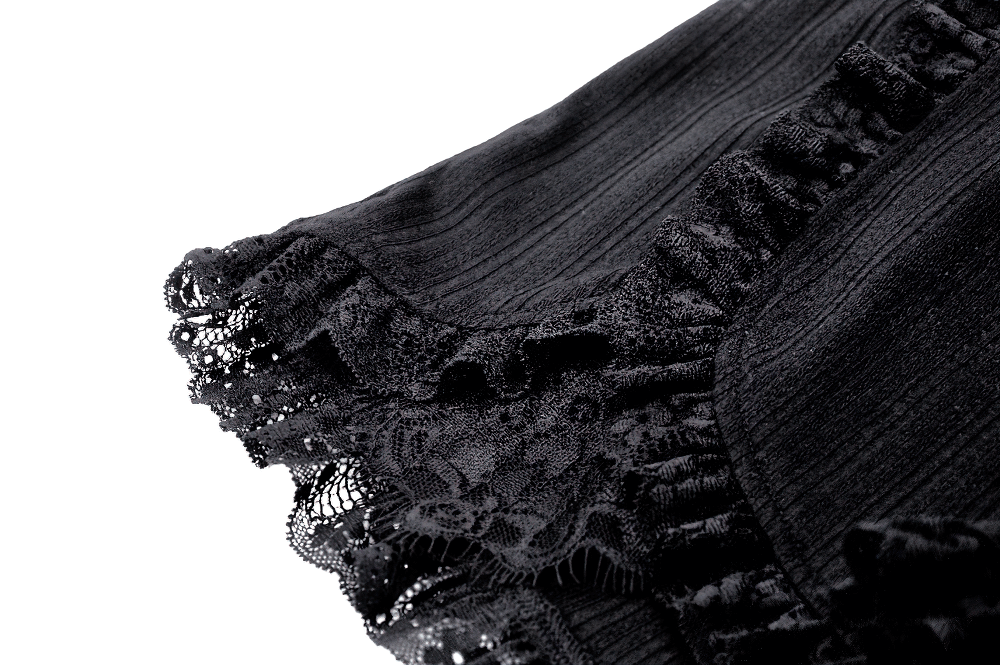 Close-up of black lace ruffled hem showcasing vintage pinstripe detail on elegant high-waisted shorts.