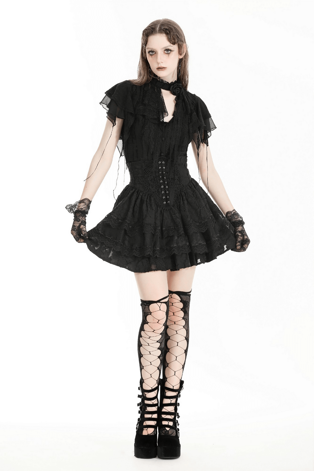 Gothic black tiered dress with lace details and fishnet stockings, perfect for dramatic fashion styling.