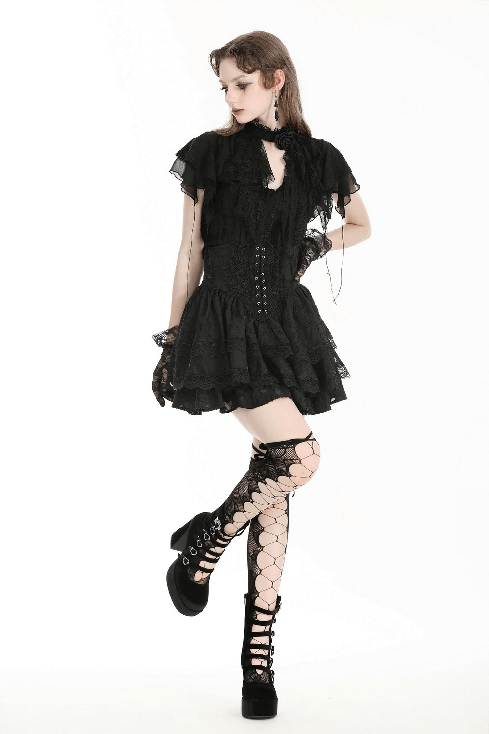 Victorian-inspired black layered dress with lace details and lace-up boots, perfect for gothic fashion enthusiasts.