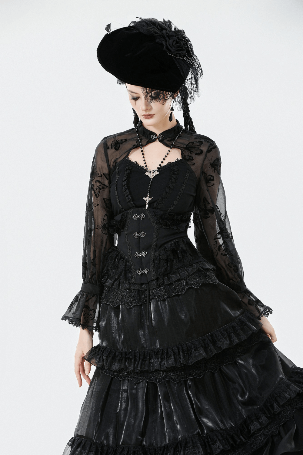 Lace-Trimmed Black Gothic Corset with Front Clasp Closure worn with a flowing black gothic skirt and chic accessories.