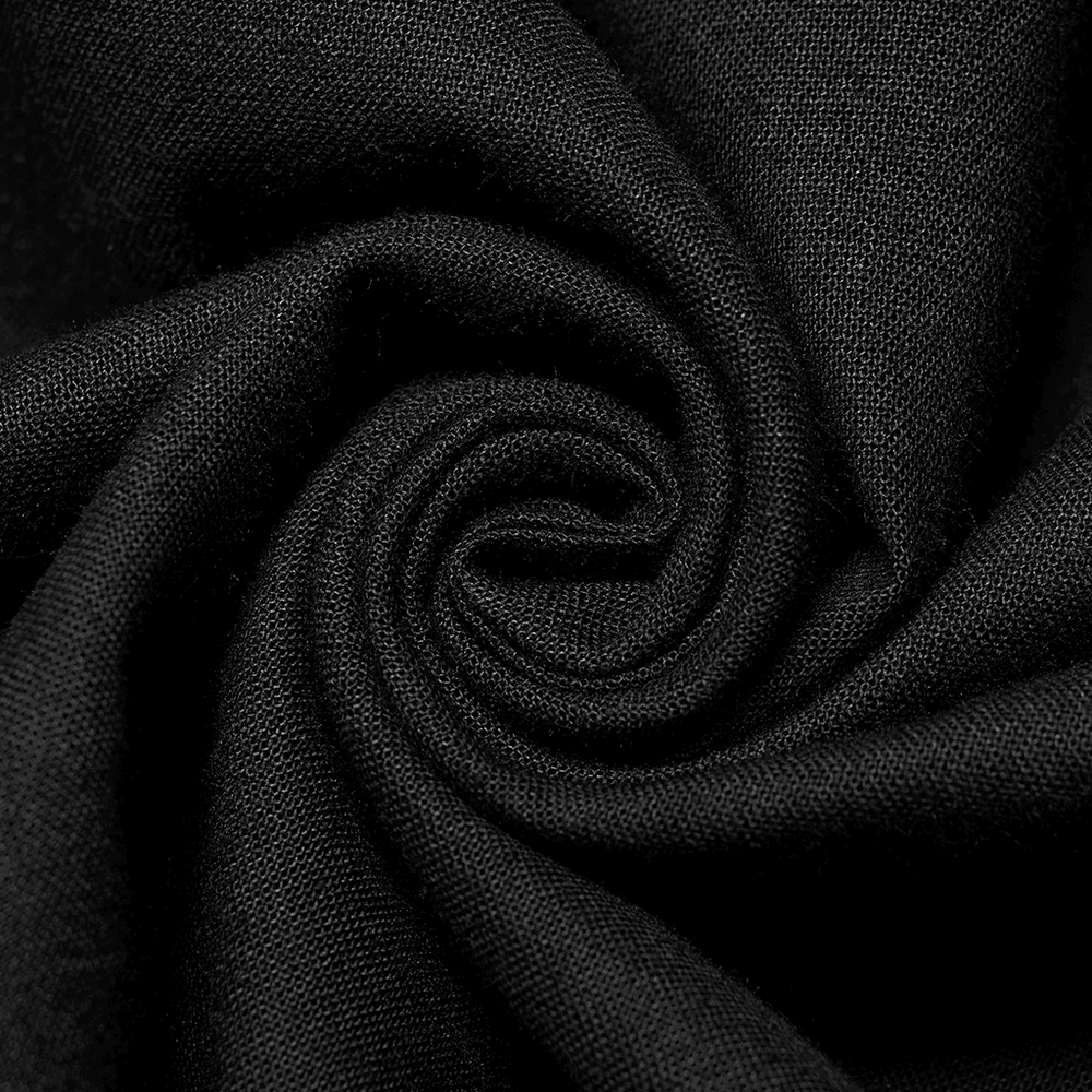 Close-up of black cotton fabric, showcasing a smooth swirl texture ideal for elegant gothic apparel.