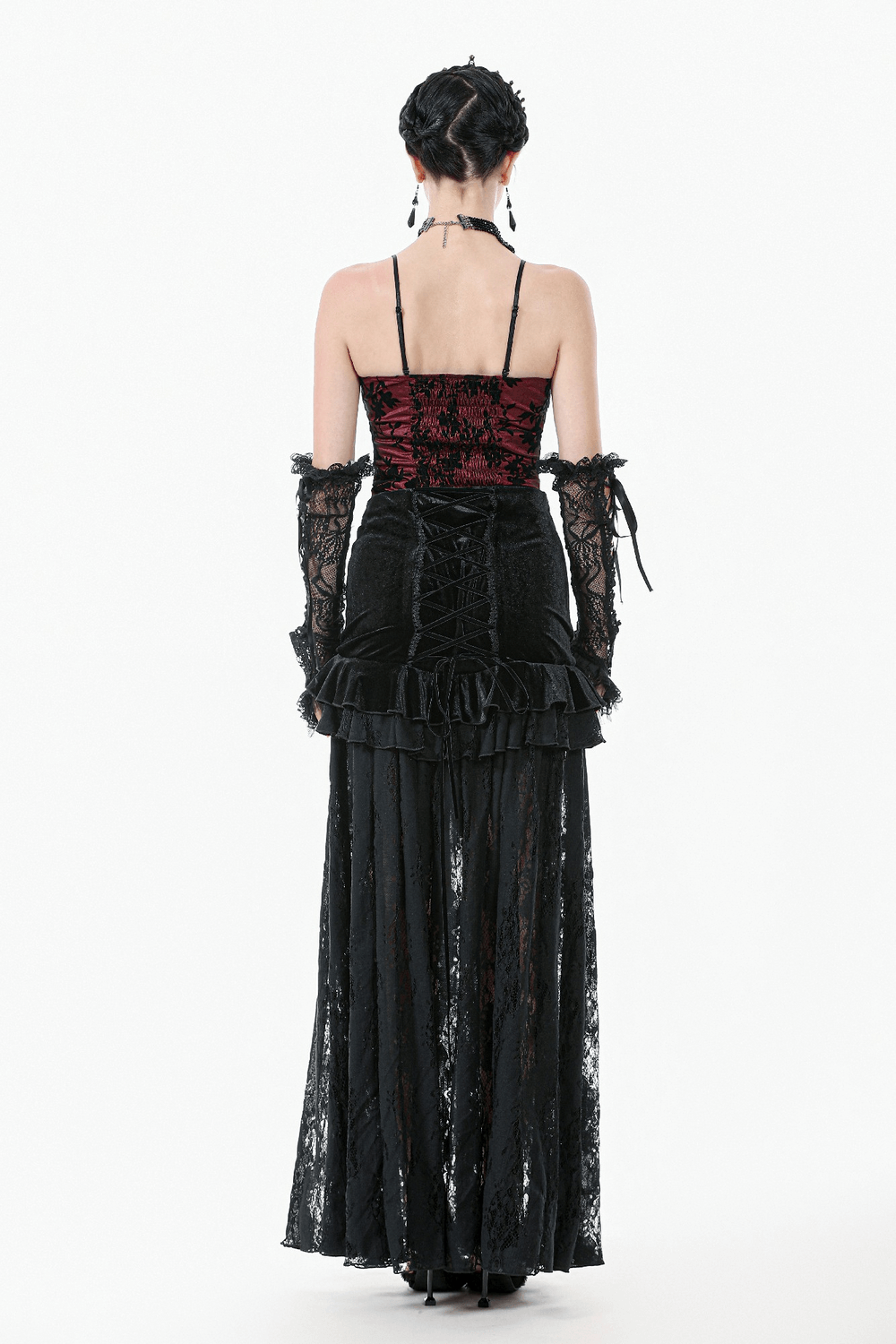 Back view of a model in a gothic-style outfit with a lace skirt and velvet corset top in black and red.