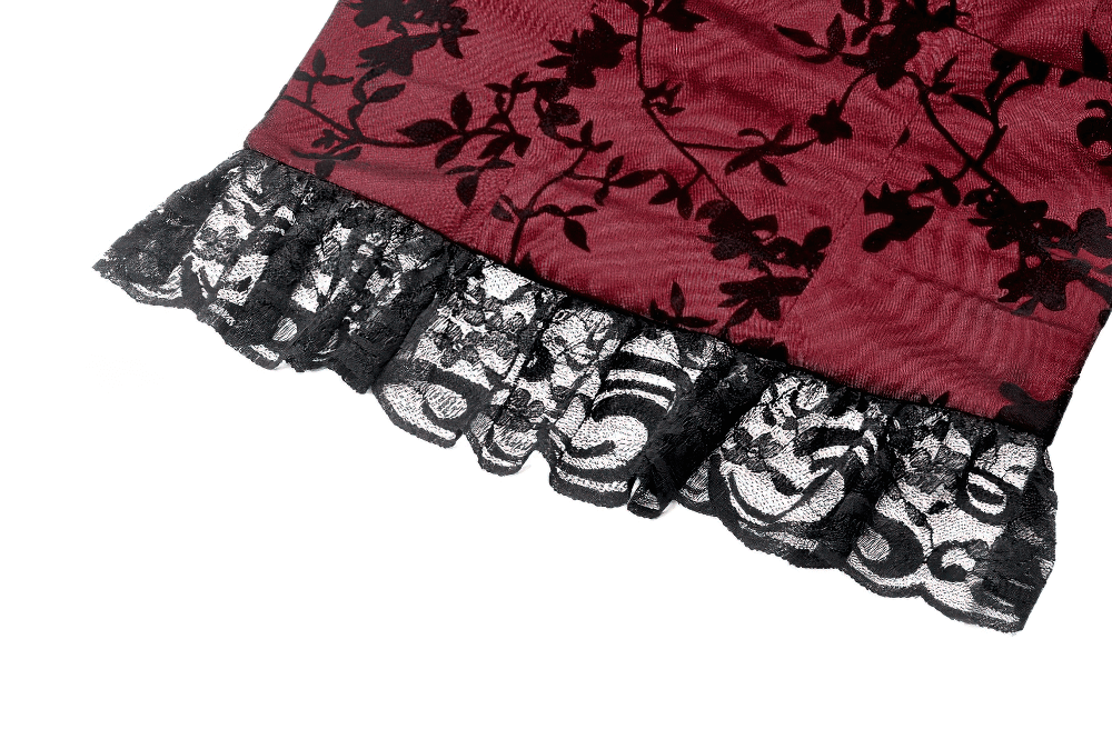 Close-up of lace-trimmed burgundy fabric with floral design, showcasing elegant black lace frill detail.