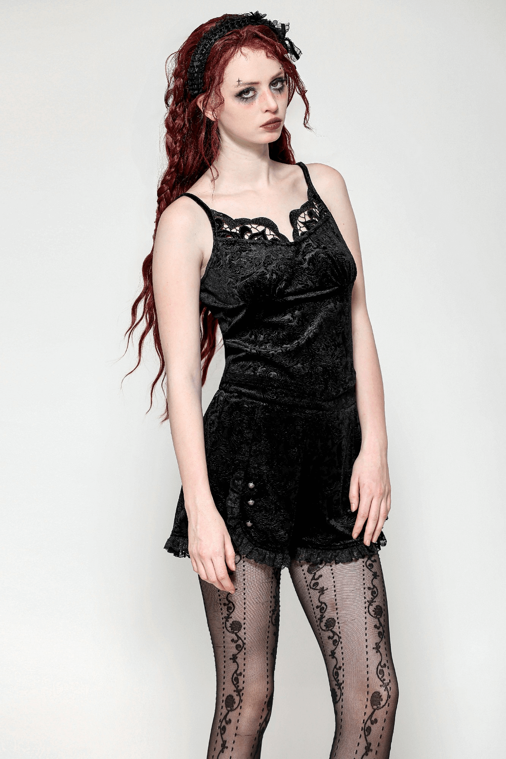 Lace-trimmed velvet high-waisted shorts with buttons, stylishly paired with fishnet tights.