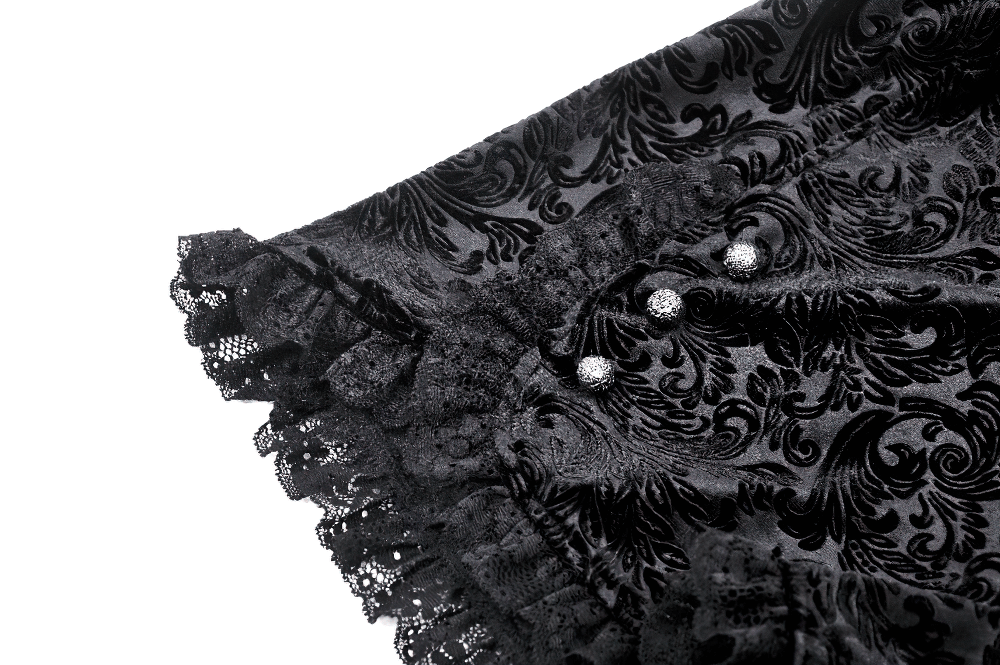 Lace-trimmed velvet high-waisted shorts with decorative buttons and elegant black patterned fabric.